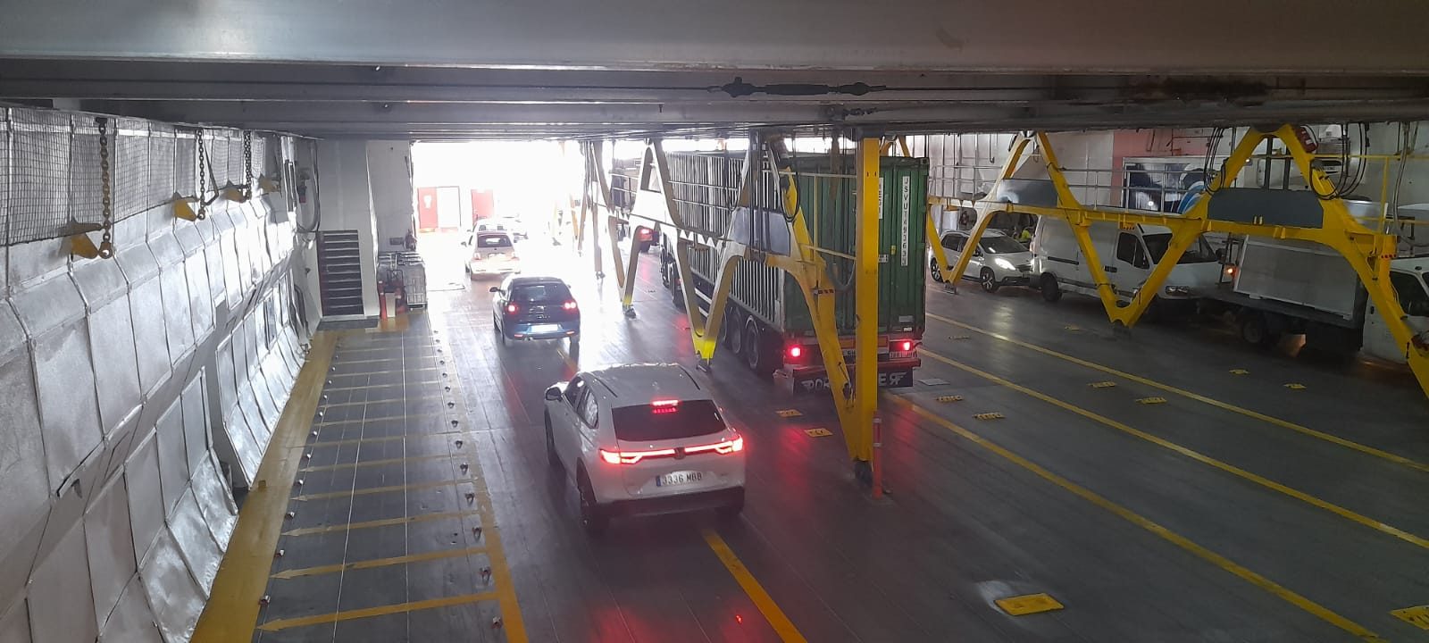 Vehicles and trucks loaded on the vessel's cargo deck